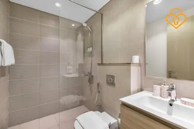a bathroom with a shower and a toilet and a sink at Keysplease 4BR, Garden BBQ, Malibu Beach Access, Damac Hills 40 in Dubai