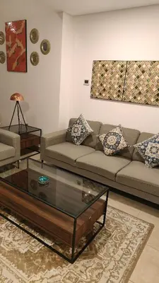 a living room with a couch and a glass coffee table at Huge Exclusive Comfortable Studio With Canal View! in Dubai