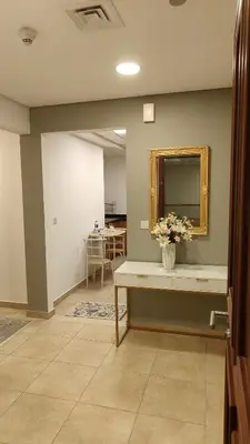 a room with a counter with a mirror and flowers on it at Huge Exclusive Comfortable Studio With Canal View! in Dubai