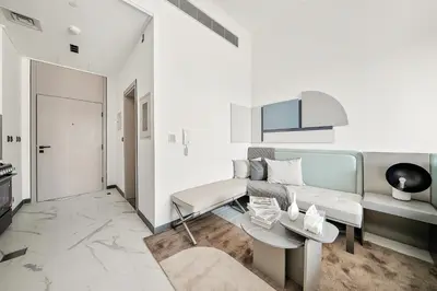 a living room with a couch and a table at Bright Studio in MAG Eye in Dubai