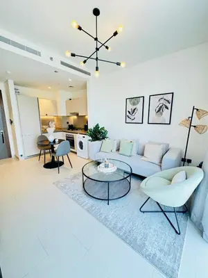 a living room with a couch and a table at Creek Views 1 BR, Mins to Downtown in Sobha Creek Vistas in Dubai