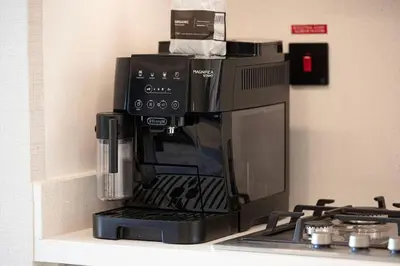 a black coffee maker sitting on a shelf next to a stove at Luxury 2BR Burj Khalifa View Dubai Mall in Dubai