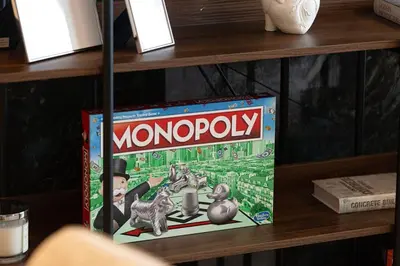a monopoly board game sitting on a shelf at Luxury 2BR Burj Khalifa View Dubai Mall in Dubai