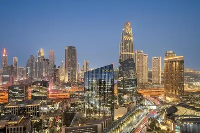 a view of a large city at night at FIRST CLASS 3BR Burj Khalifa & Fountain View in Dubai