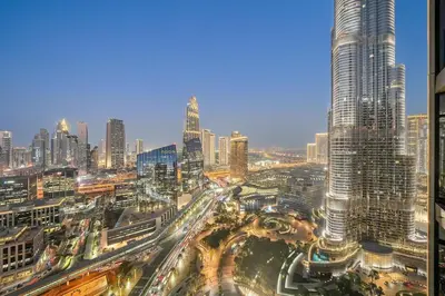 a view of a city at night with traffic at FIRST CLASS 3BR Burj Khalifa & Fountain View in Dubai