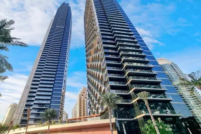 two tall buildings with palm trees in front of them at FIRST CLASS 3BR Burj Khalifa & Fountain View in Dubai