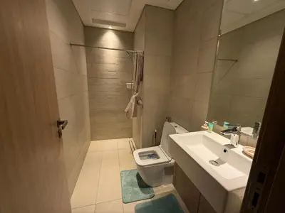a bathroom with a toilet and a sink at Cozy 01 BHK with Balcony in Dubai