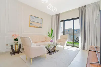 a living room with a couch and a glass table at Escape24 Modern 1BR with Pool View in JVC in Dubai