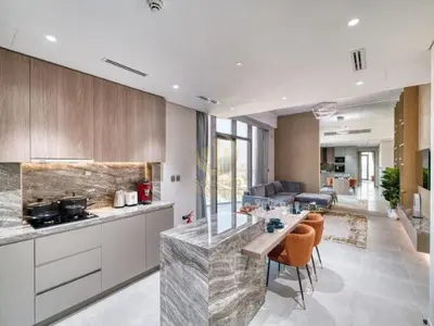 a kitchen with a counter and a living room at Luxury 1BR Larger Layout Westwood Grande - 1103 in Dubai