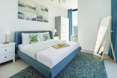 a bedroom with a bed with a tray on it at Frank Porter - Address JBR in Dubai