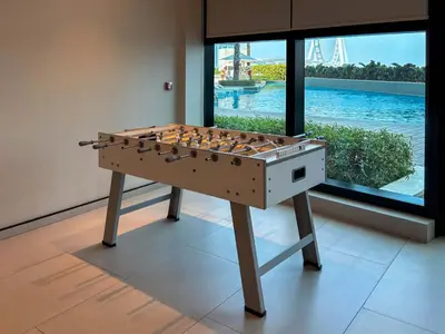 a foosball table in a room with a window at Frank Porter - Address JBR in Dubai