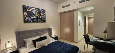 a bedroom with a king sized bed and a desk at Studio Uni at Azizi Riviera 43 Near Business Bay in Dubai