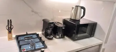 a kitchen counter with a coffee maker and a blender at Studio Uni at Azizi Riviera 43 Near Business Bay in Dubai