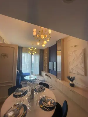 a dining room with a table and a chandelier at Elegant 1BR at Sparkle T1 With Marina View Near Beach in Dubai