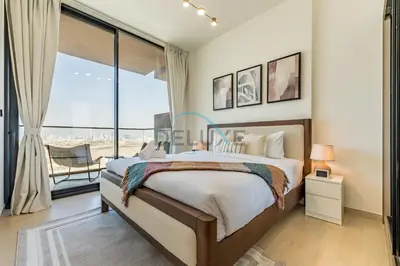 a bedroom with a large bed and a large window at Delightful 1BR in Binghatti Corner, Jumeirah Village Circle by Deluxe Holiday Homes in Dubai