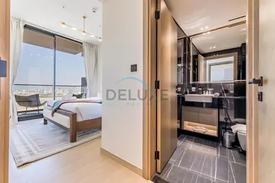 a bedroom with a bed and a bathroom with a sink at Delightful 1BR in Binghatti Corner, Jumeirah Village Circle by Deluxe Holiday Homes in Dubai