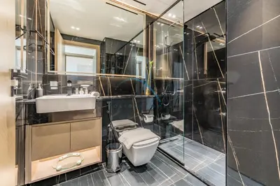 a bathroom with a toilet and a sink and a shower at Delightful 1BR in Binghatti Corner, Jumeirah Village Circle by Deluxe Holiday Homes in Dubai