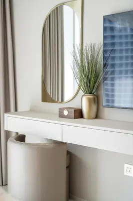 a mirror on a white shelf with a potted plant at Grand Bleu 02 - LIMITED OFFER! 1BR Coastal Retreat at Emaar Beachfront in Dubai