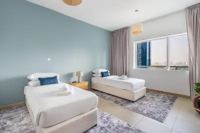 a hotel room with two beds and a window at GuestReady - Coastal vibes in Dubai Marina in Dubai