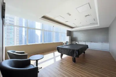 a room with a piano and chairs in a building at GuestReady - Coastal vibes in Dubai Marina in Dubai