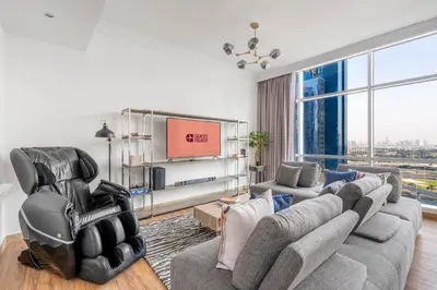 a living room with a couch and a tv at GuestReady - Coastal vibes in Dubai Marina in Dubai