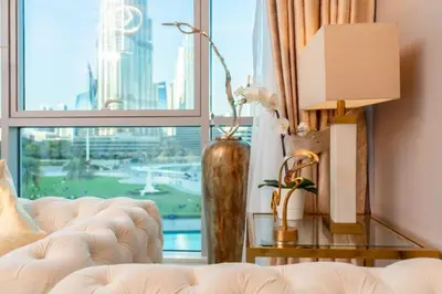 a living room with a couch and a large window at Elite Royal Apartment - Full Burj Khalifa & Fountain View - Largest Layout - Half Floor - Luxurious - Archon in Dubai