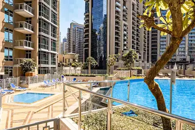 a balcony with a swimming pool in a city at Elite Royal Apartment - Full Burj Khalifa & Fountain View - Largest Layout - Half Floor - Luxurious - Archon in Dubai