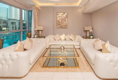 a living room with white couches and a glass coffee table at Elite Royal Apartment - Full Burj Khalifa & Fountain View - Largest Layout - Half Floor - Luxurious - Archon in Dubai