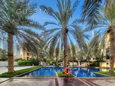 a pool with palm trees and a no swimming sign at Zaafaran 1 by Emaar, Downtown Dubai in Dubai