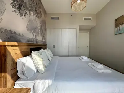 a bedroom with a bed with two towels on it at Elegant 3 Bed in Park Point, Dubai Hills Estate in Dubai