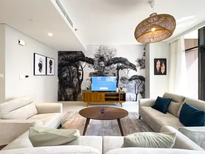 a living room with a couch and a tv at Elegant 3 Bed in Park Point, Dubai Hills Estate in Dubai
