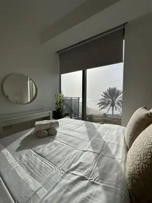 a bedroom with a large bed with a large window at Sea View Luxury 5242 Marina JBR Beach 5mins in Dubai