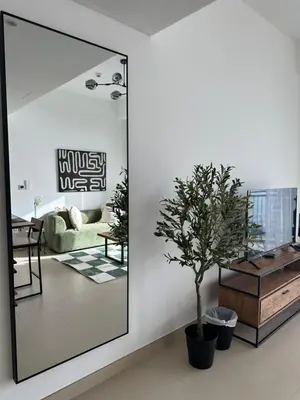a mirror in a living room with a tree at Sea View Luxury 5242 Marina JBR Beach 5mins in Dubai