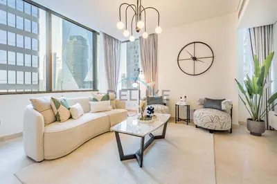 a living room with a couch and a table at Modern 2BR in Sky Gardens, DIFC by Deluxe Holiday Homes in Dubai