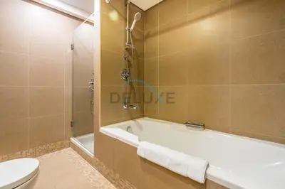 a bathroom with a bath tub and a toilet at Modern 2BR in Sky Gardens, DIFC by Deluxe Holiday Homes in Dubai