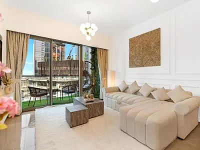 a living room with a couch and a table at Signature Series 1 Bedroom Apartment I Free Parking, Gym, Pool I PlayStation 5 I by Skyline Serenity in Dubai