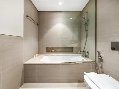 a large bathroom with a tub and a sink at Signature Series 1 Bedroom Apartment I Free Parking, Gym, Pool I PlayStation 5 I by Skyline Serenity in Dubai