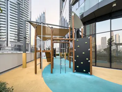 a playground in a high rise building with a view of the city at Signature Series 1 Bedroom Apartment I Free Parking, Gym, Pool I PlayStation 5 I by Skyline Serenity in Dubai