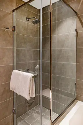 a shower with a glass door in a bathroom at Luxury 2BR Prime Location & Burj Views in Dubai