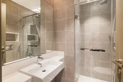 a bathroom with a sink and a shower at Luxury 2BR Prime Location & Burj Views in Dubai