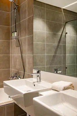 a bathroom with a sink and a mirror at Luxury 2BR Prime Location & Burj Views in Dubai