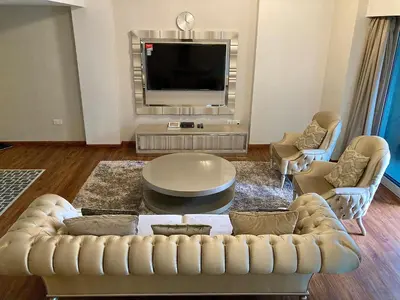 a living room with a couch and a tv at Executive Tower 1bhk Business Bay in Dubai