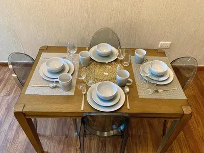 a wooden table with plates and dishes on it at Executive Tower 1bhk Business Bay in Dubai