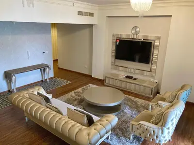 a living room with a couch and a tv at Executive Tower 1bhk Business Bay in Dubai
