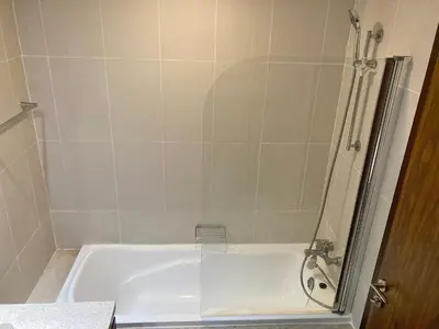 a bathroom with a bath tub with a shower at Executive Tower 1bhk Business Bay in Dubai