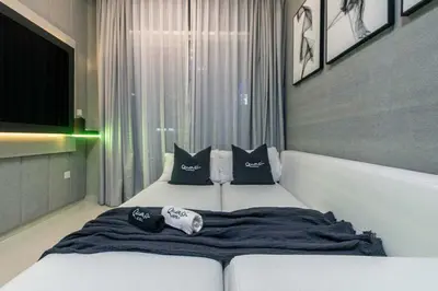 a bedroom with a bed with pillows on it at Luxury 2BD Apt with Pool GYM & Burj Khalifa Views in Dubai