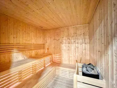 a wooden sauna with a black bag sitting in it at Luxury 2BD Apt with Pool GYM & Burj Khalifa Views in Dubai