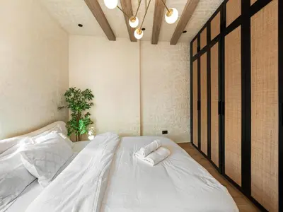 a bedroom with a large white bed with two pillows at Luxury Penthouse In The Heart of Dubai Marina in Dubai