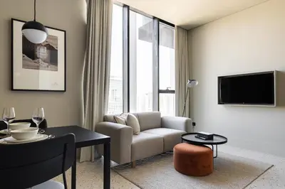 a living room with a couch and a table at Upside Living Business Bay Stunning Panoramic Burj Cityline Views by Simply Comfort in Dubai