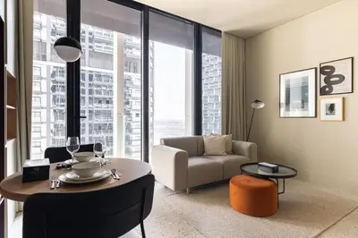 a living room with a couch and a table at Upside Living Business Bay Stunning Panoramic Burj Cityline Views by Simply Comfort in Dubai